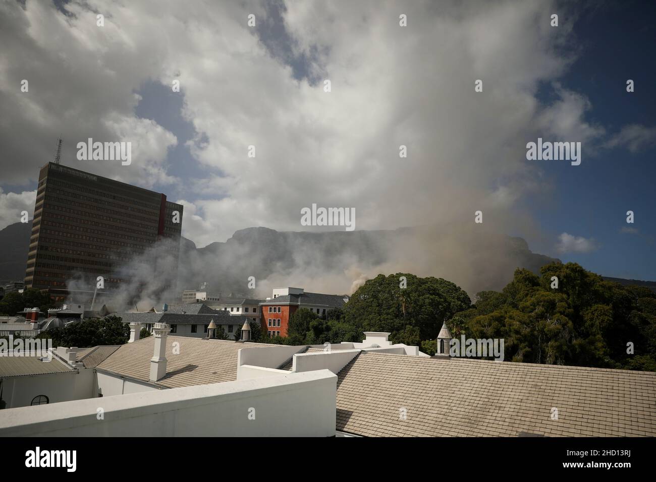 Smoke rises after a fire broke out at the parliament in Cape Town, South Africa, January 2, 2022. REUTERS/Mike Hutchings Stock Photo