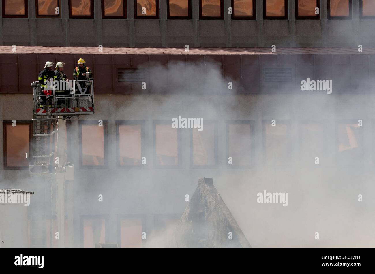 Firemen survey the damage after a fire broke out at parliament in Cape Town, South Africa, January 2, 2022. REUTERS/Mike Hutchings Stock Photo