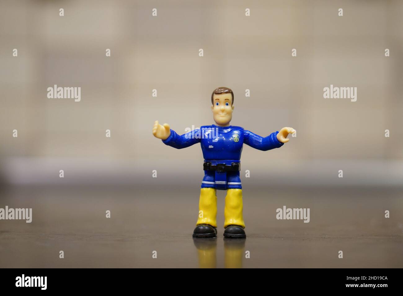 Fireman Sam toy figurine character with wide arms. Stock Photo