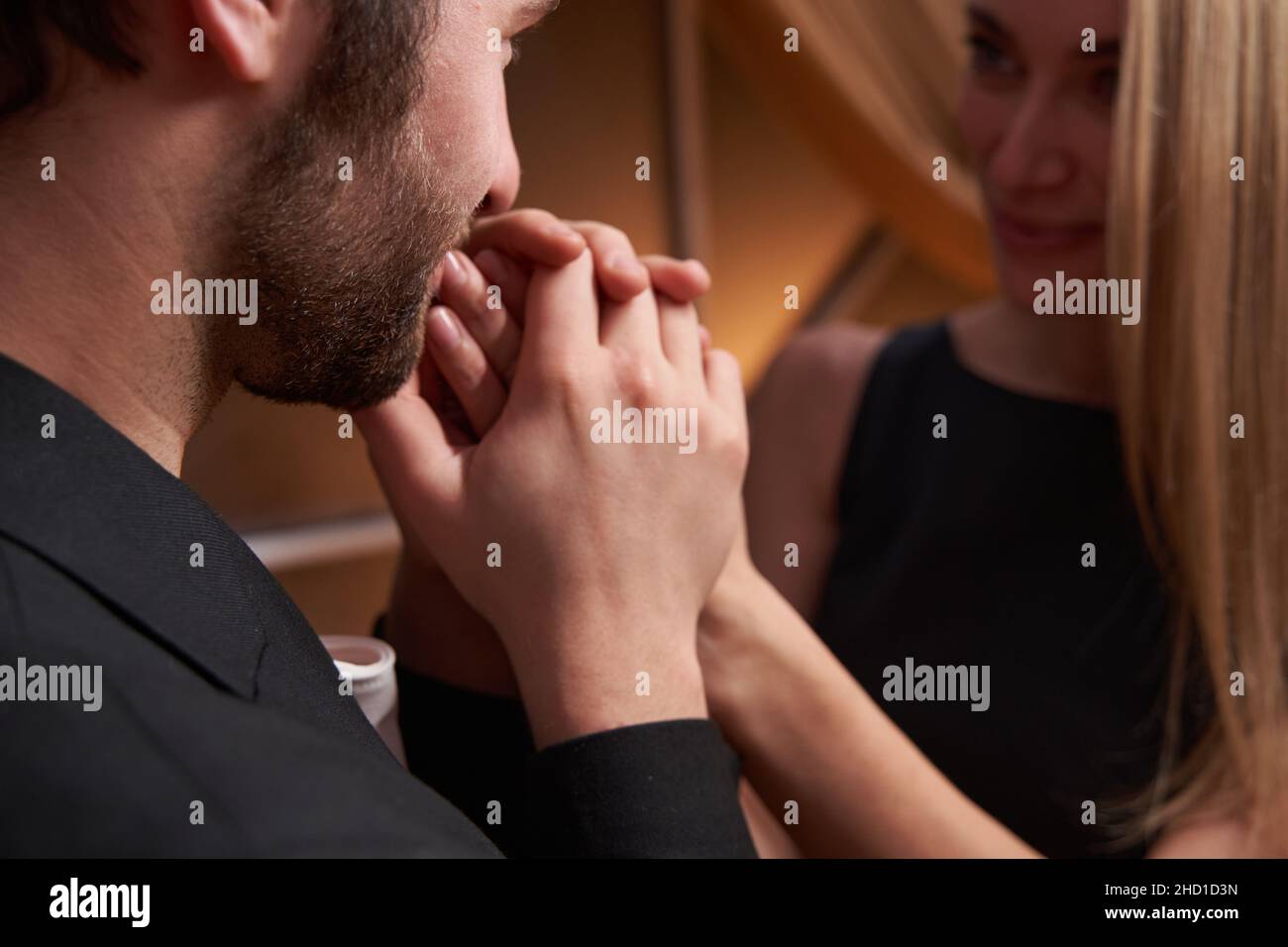 Male is kissing woman fingers in restaurant Stock Photo - Alamy