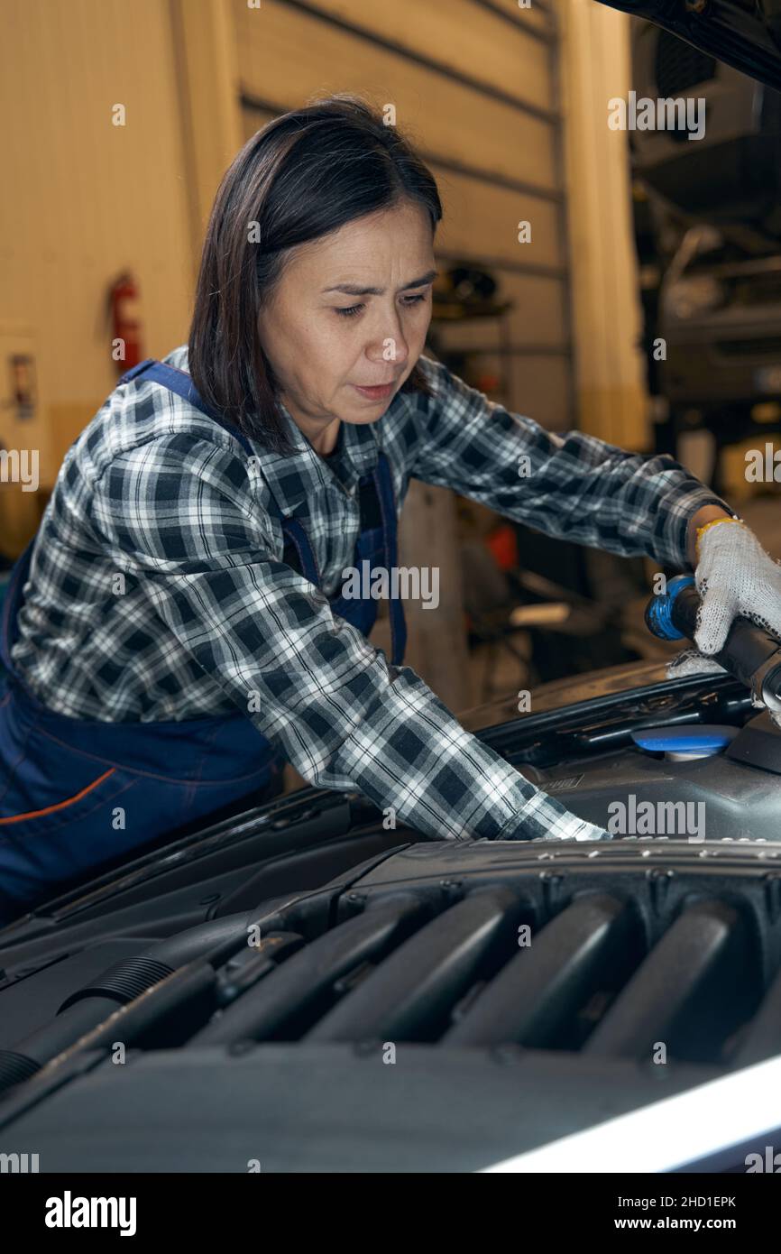 Car mechanic performing a planned inspection of a vehicle Stock Photo ...
