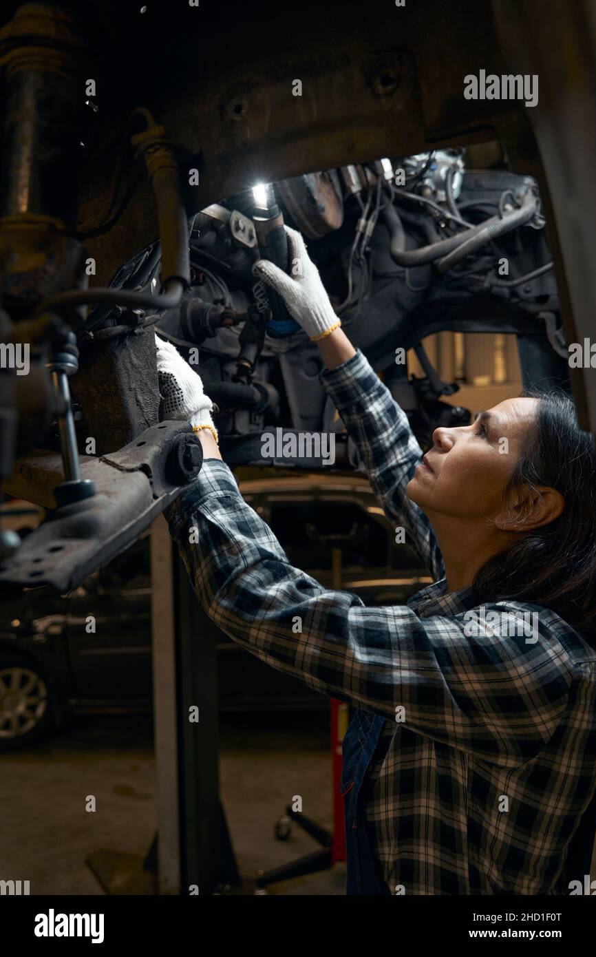 Responsible car mechanic running profound vehicle diagnostics Stock