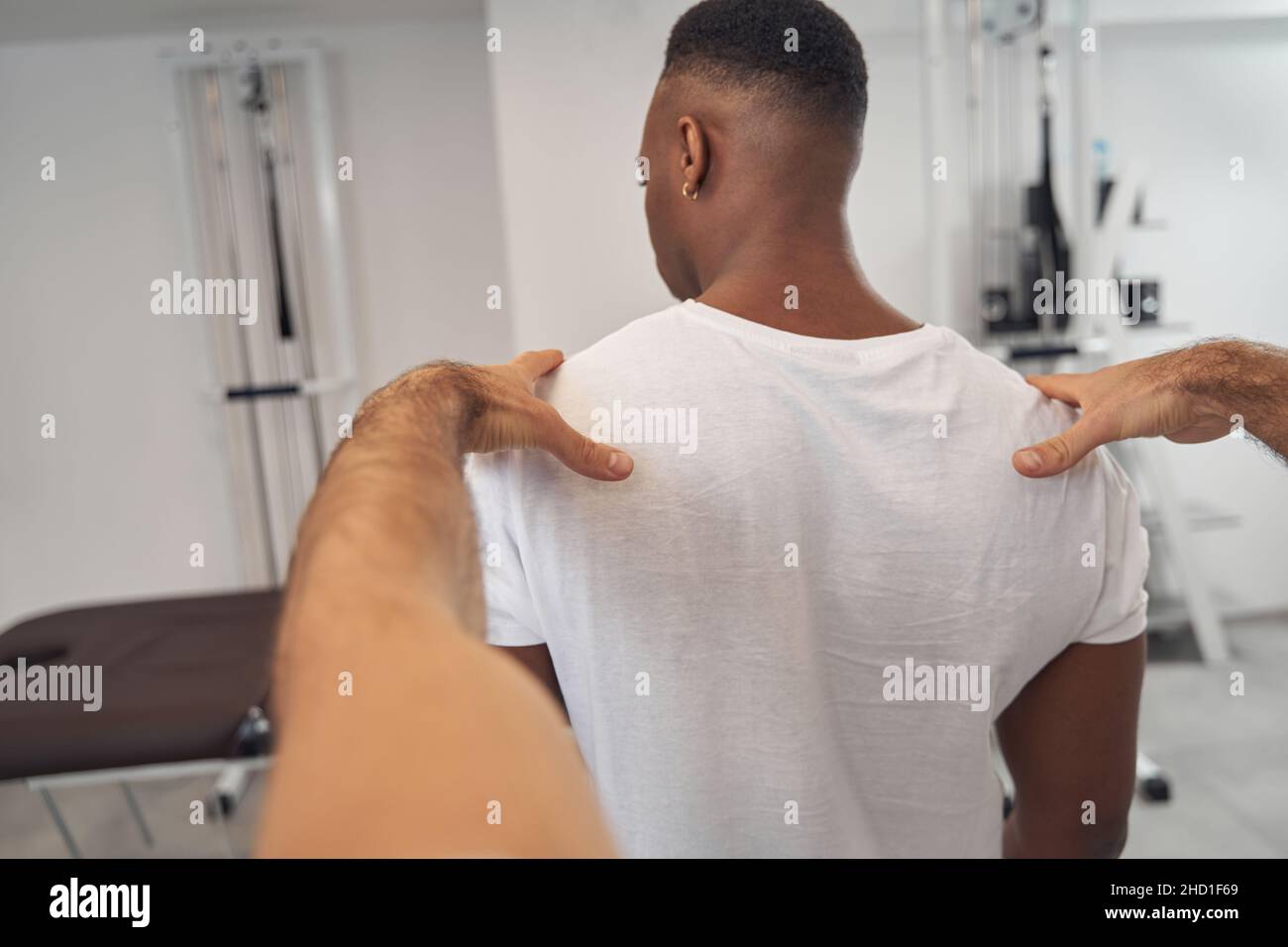 Man undergoing spine exam in standing posture Stock Photo - Alamy