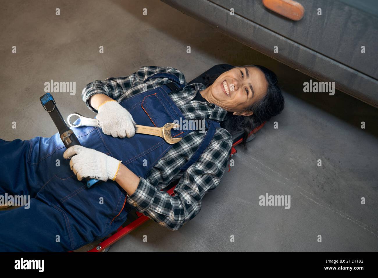Excited lady in technician uniform felling happy about her job Stock Photo