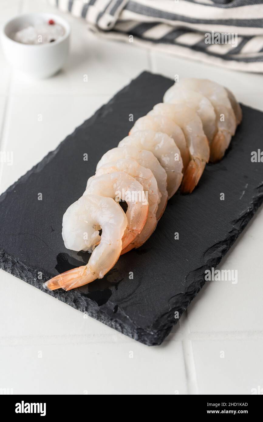 Thawed peeled shrimp, seafood, delicacy. on a white background, in a ...