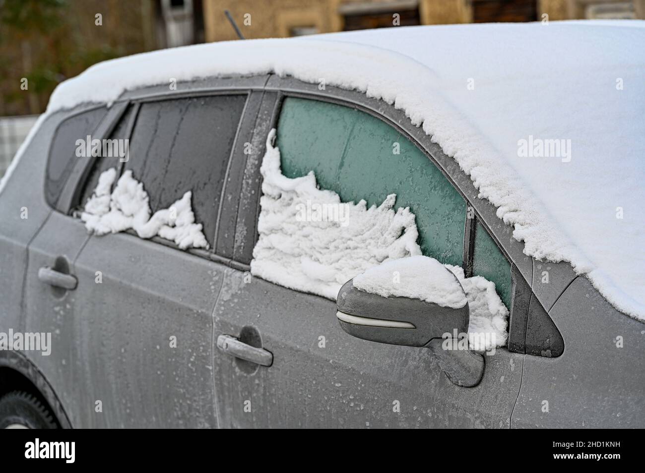 car covered in snow and ice in need of a ice scraper Stock Photo