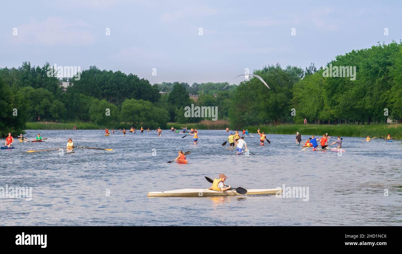 a crowd of kayakers on the water in the summer on the river Stock Photo