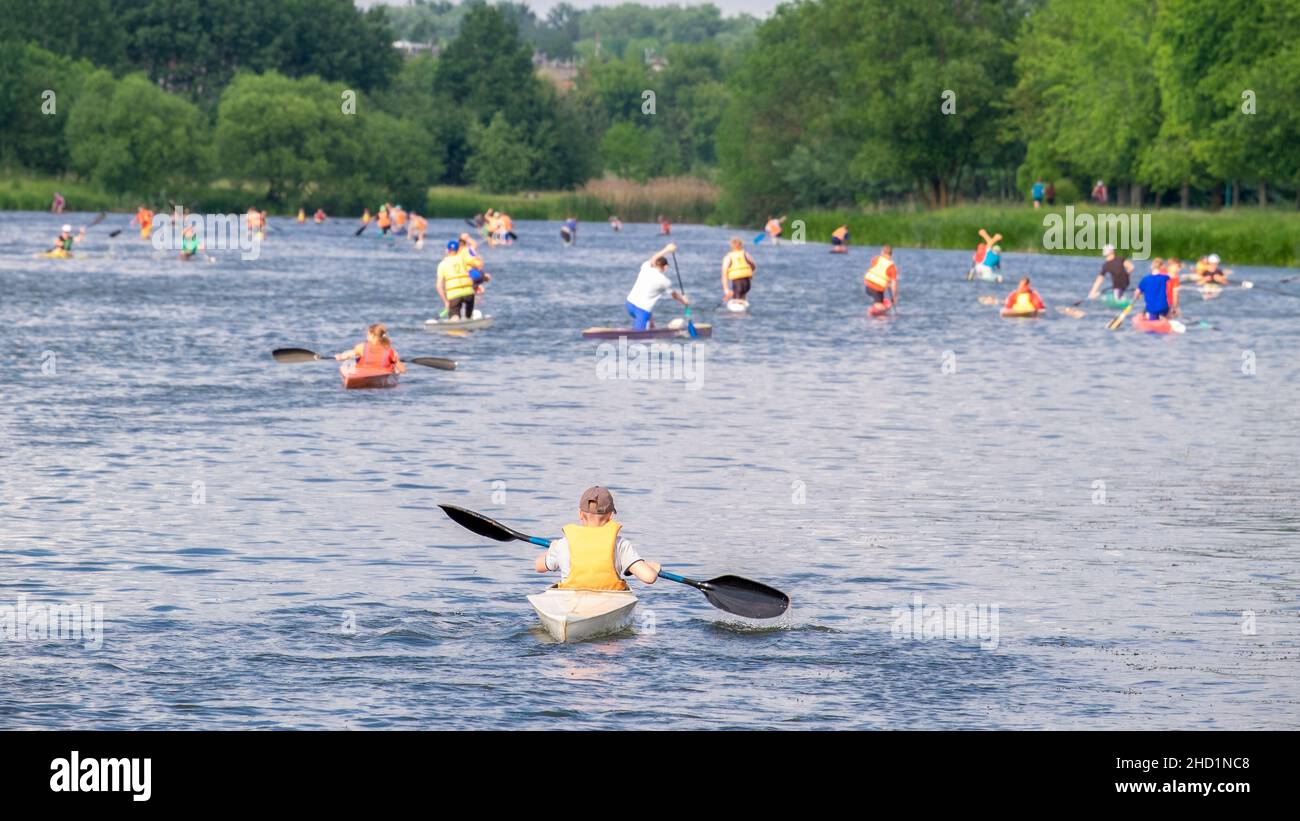 a crowd of kayakers on the water in the summer on the river Stock Photo
