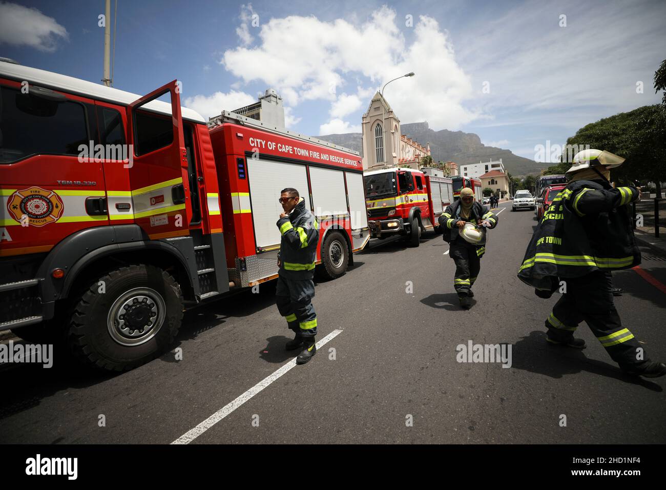 Firefighters deploy outside the parliament where a fire broke out in Cape Town, South Africa, January 2, 2022. REUTERS/Mike Hutchings Stock Photo