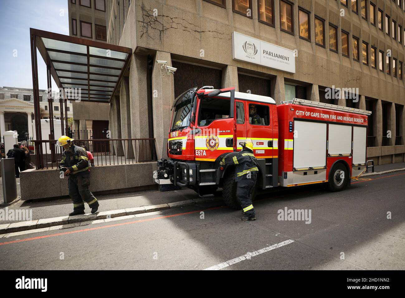 Firefighters deploy outside the parliament where a fire broke out in Cape Town, South Africa, January 2, 2022. REUTERS/Mike Hutchings Stock Photo