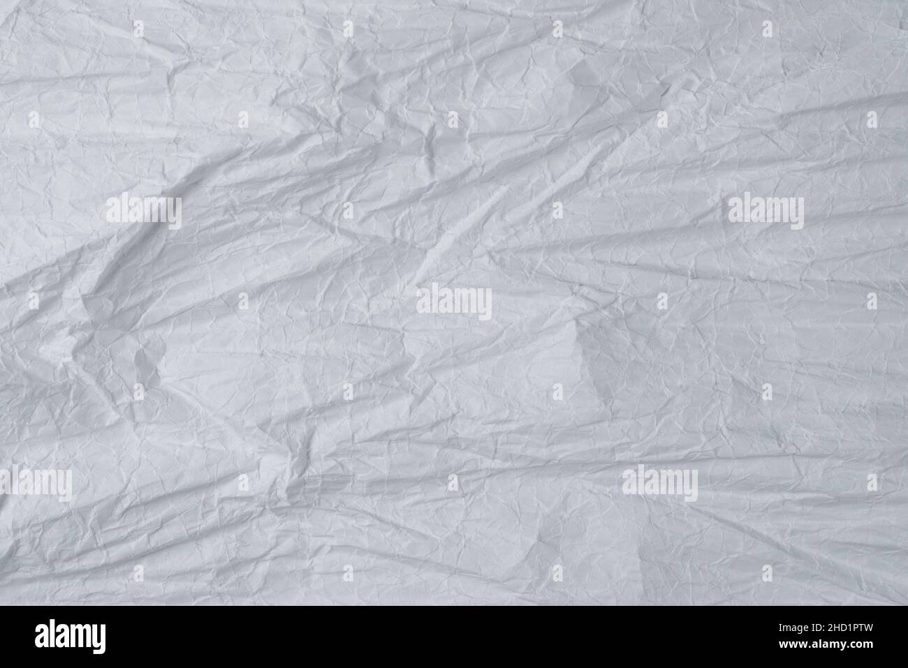 Crumpled white paper background. Top view. Copy space. Stock Photo