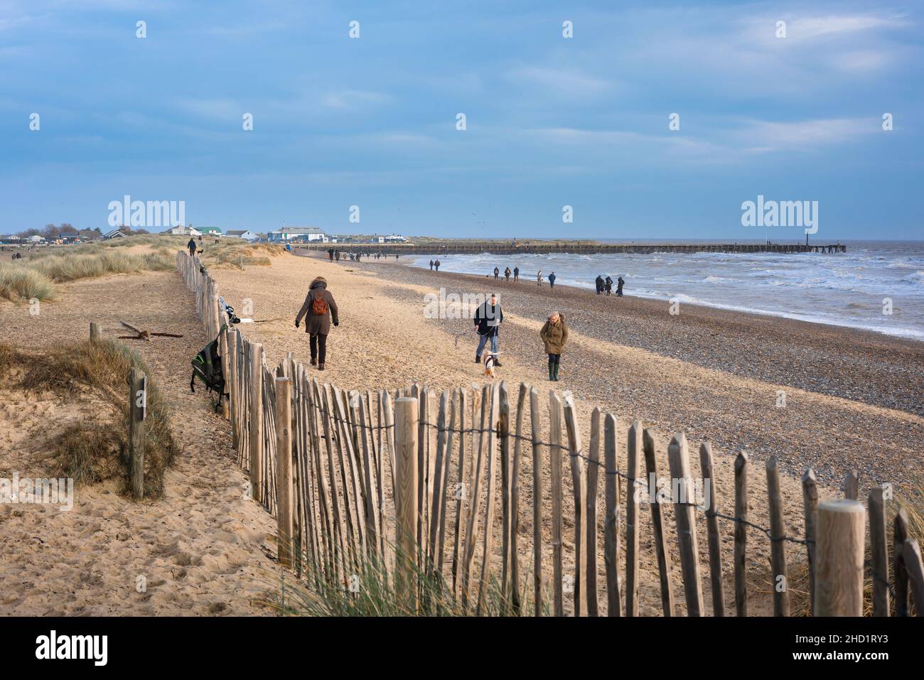 Walberswick beach, out of season view of people walking on the beach at Walberswick, Suffolk coast, England, UK Stock Photo