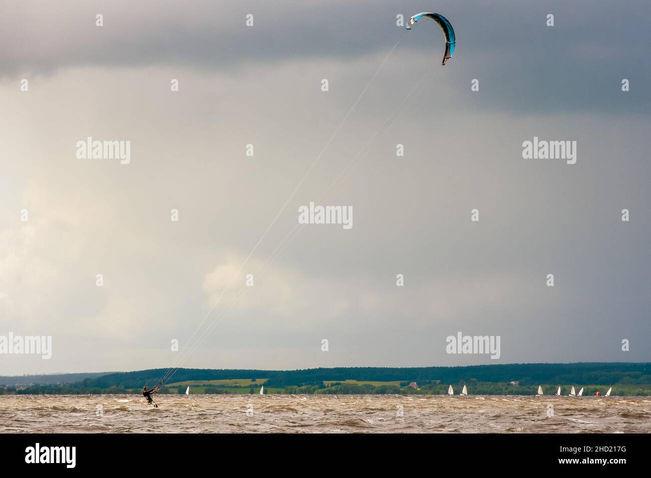 Kitesurfing on the water on the waves with a parachute wing. Wind, speed. Stock Photo
