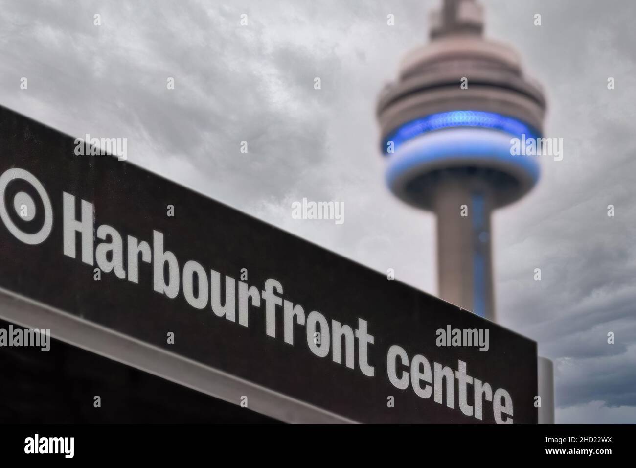 The CN Tower illuminated in blue and framed in a sign for the Harbourfront Centre. Jan. 2, 2022 Stock Photo