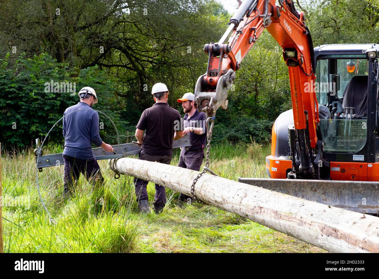 Western Power Workers Engineers And Digger Erecting A New Utility Pole 