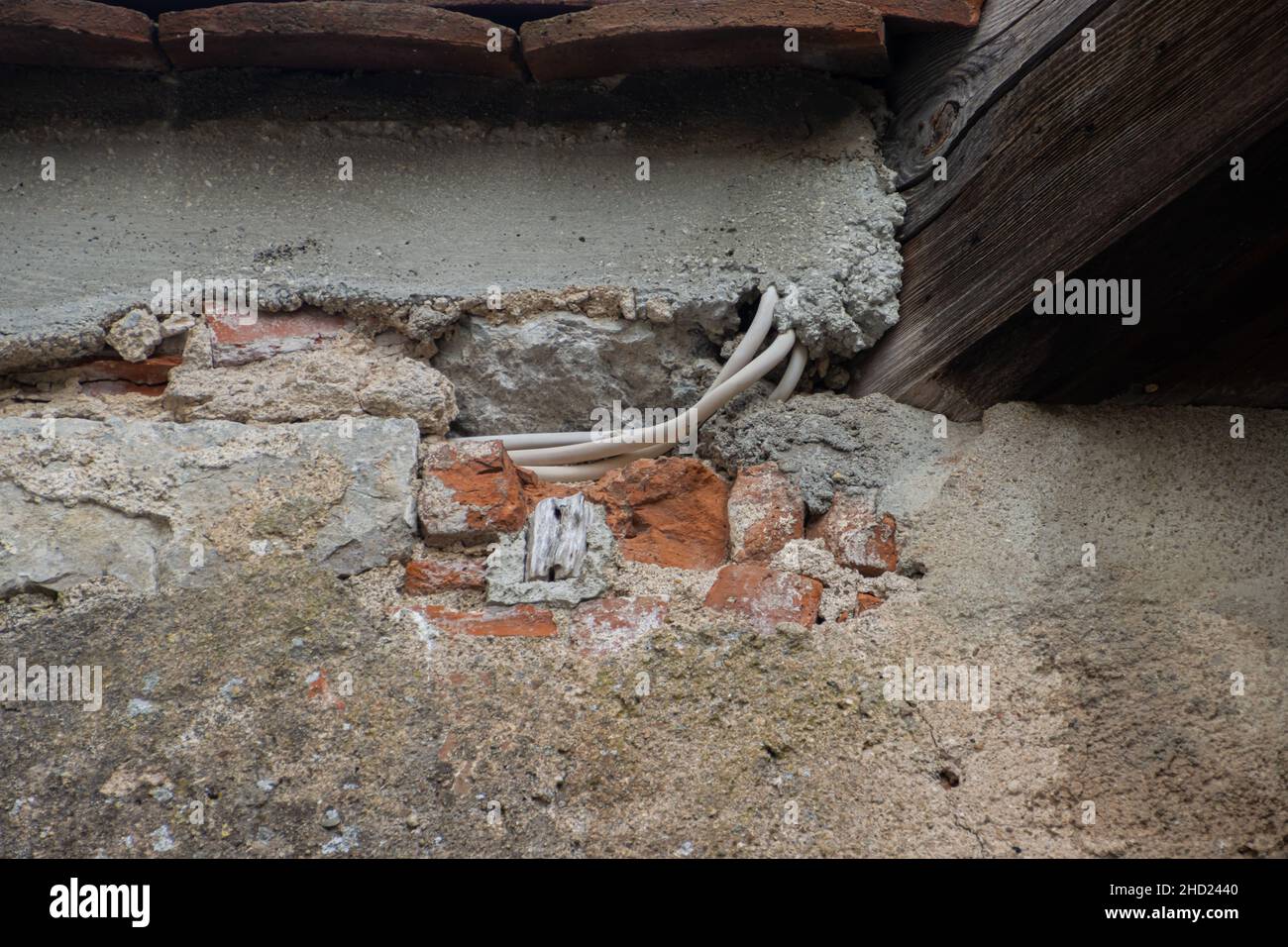 Damaged wall exposing electric wires Stock Photo Alamy