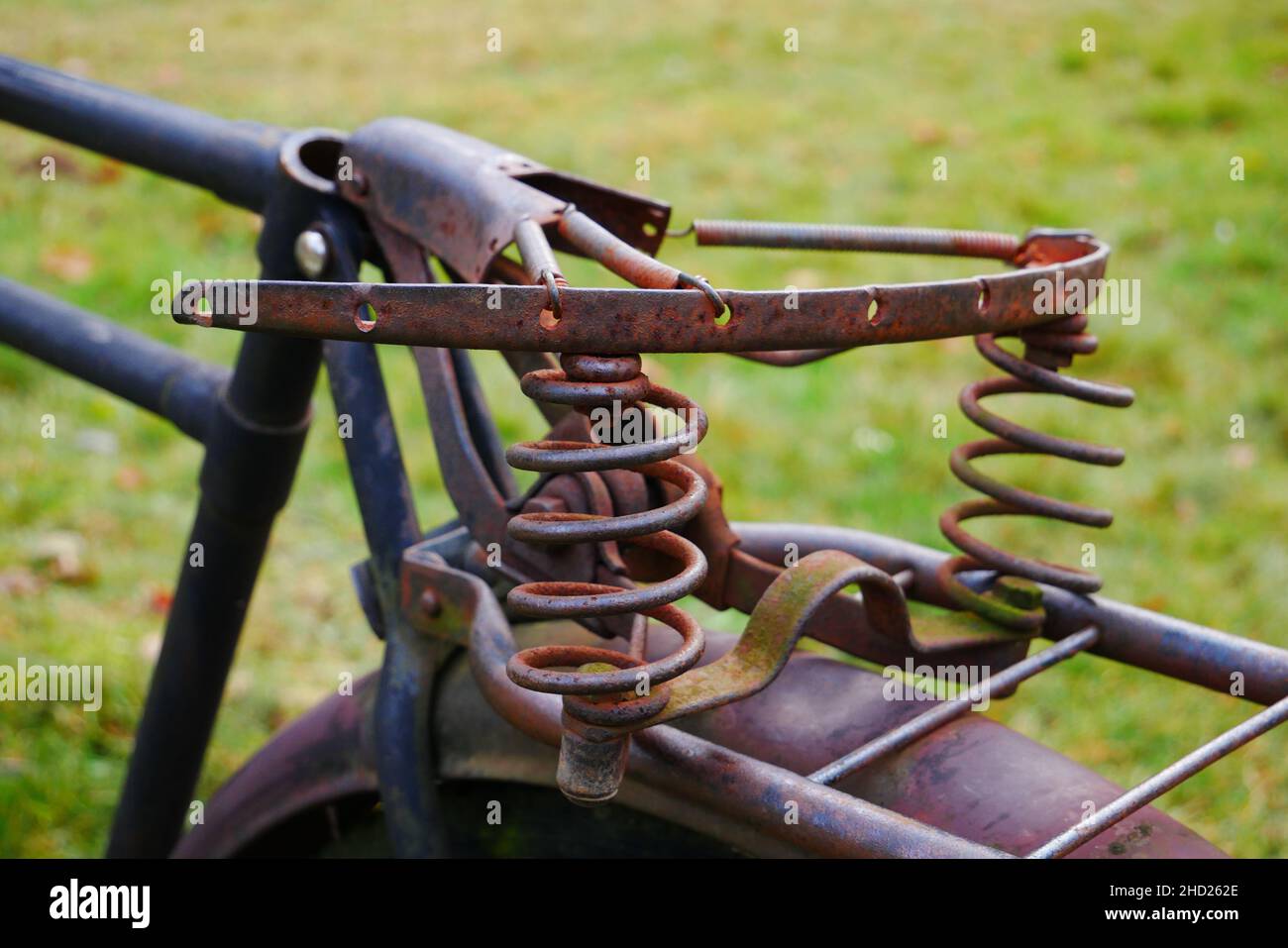 closeup of an old rusty broken saddle of an old cargo bike Stock Photo