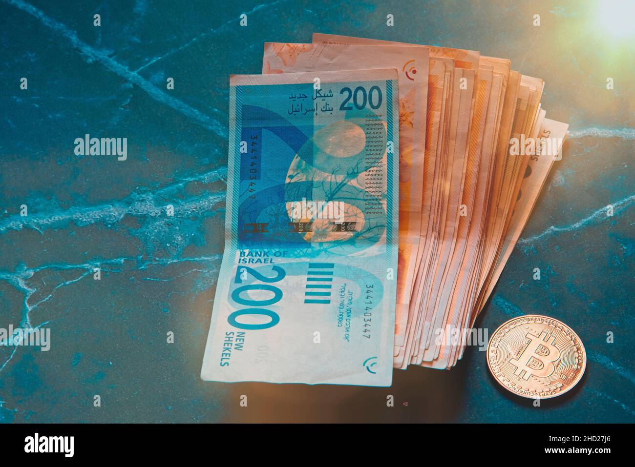 Roll Israeli Shekel ILS banknotes near cryptocurrency tokens Ethereum eth,  saw from above, on white background. Selective focus. with space for text  placement. Isolated . High quality photo Stock Photo - Alamy