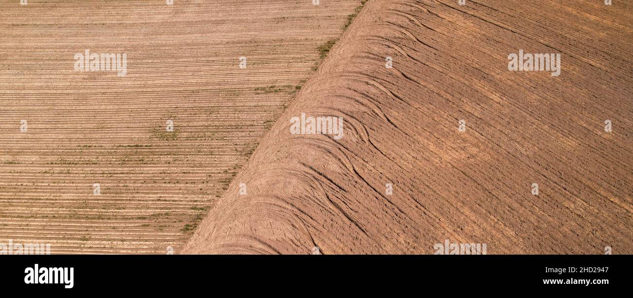Pattern of repeating wheel tread marks on a plowed field. Stock Photo