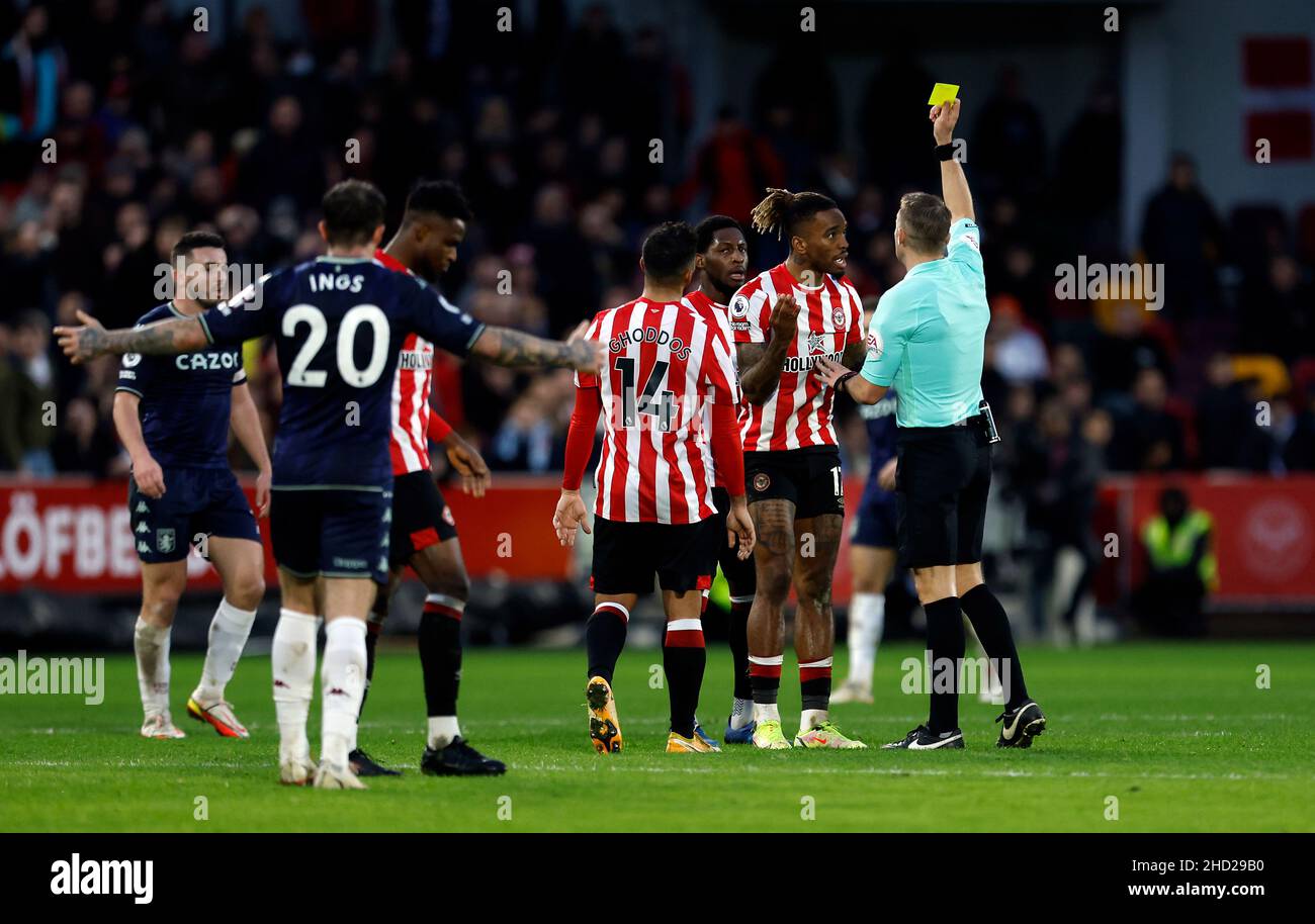 Brentford's Ivan Toney is shown a yellow card by referee Craig Pawson