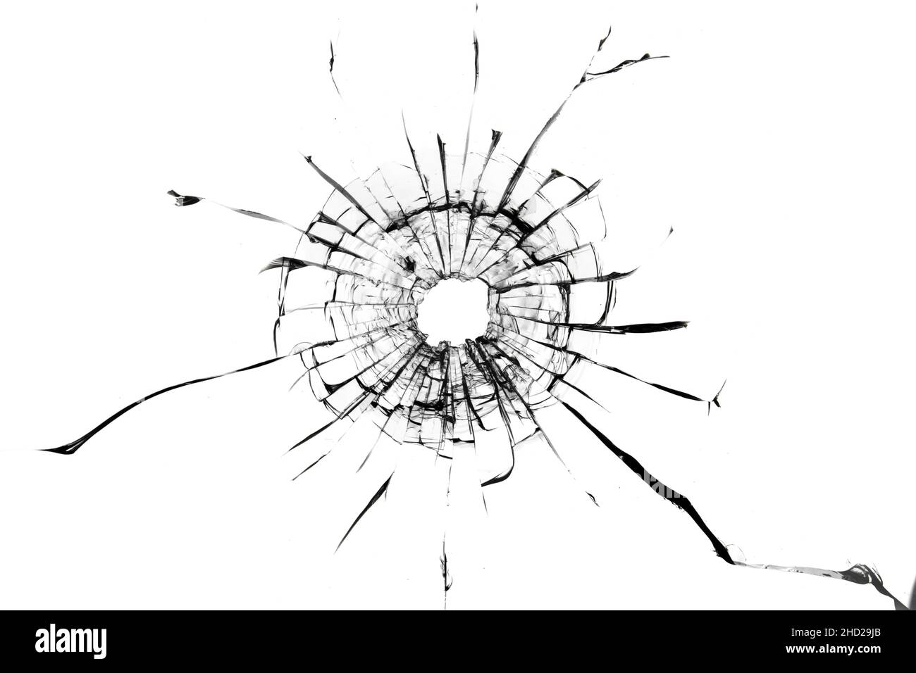 Shot hole, texture of cracks on the glass. Broken windshield. Damaged car window. Stock Photo