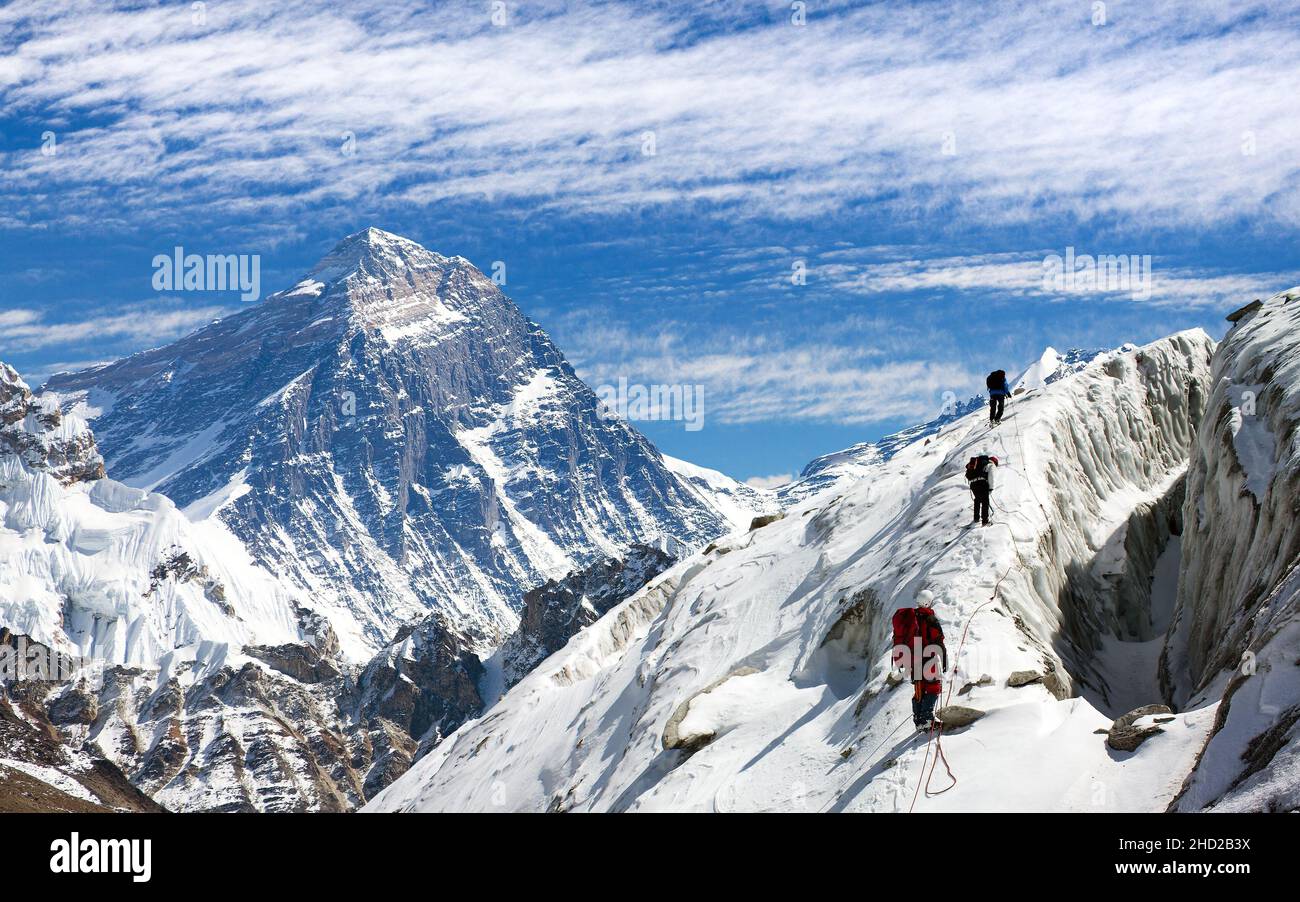 view of Everest and Lhotse from Gokyo valley with group of climbers on glacier, way to Everest base camp, Sagarmatha national park, Khumbu valley, Nep Stock Photo