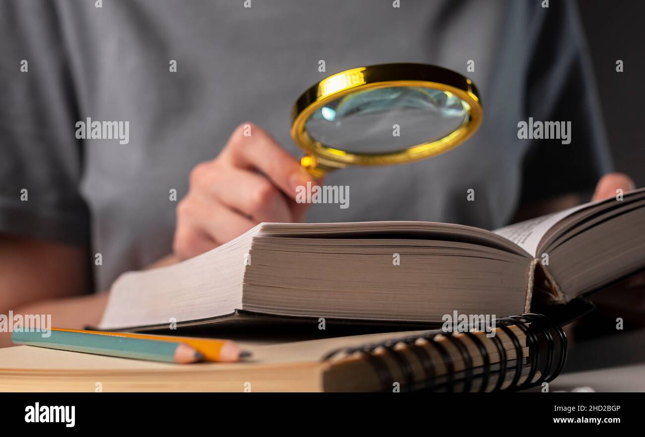 Female student hands holding pencil and reading book, prepare for exam