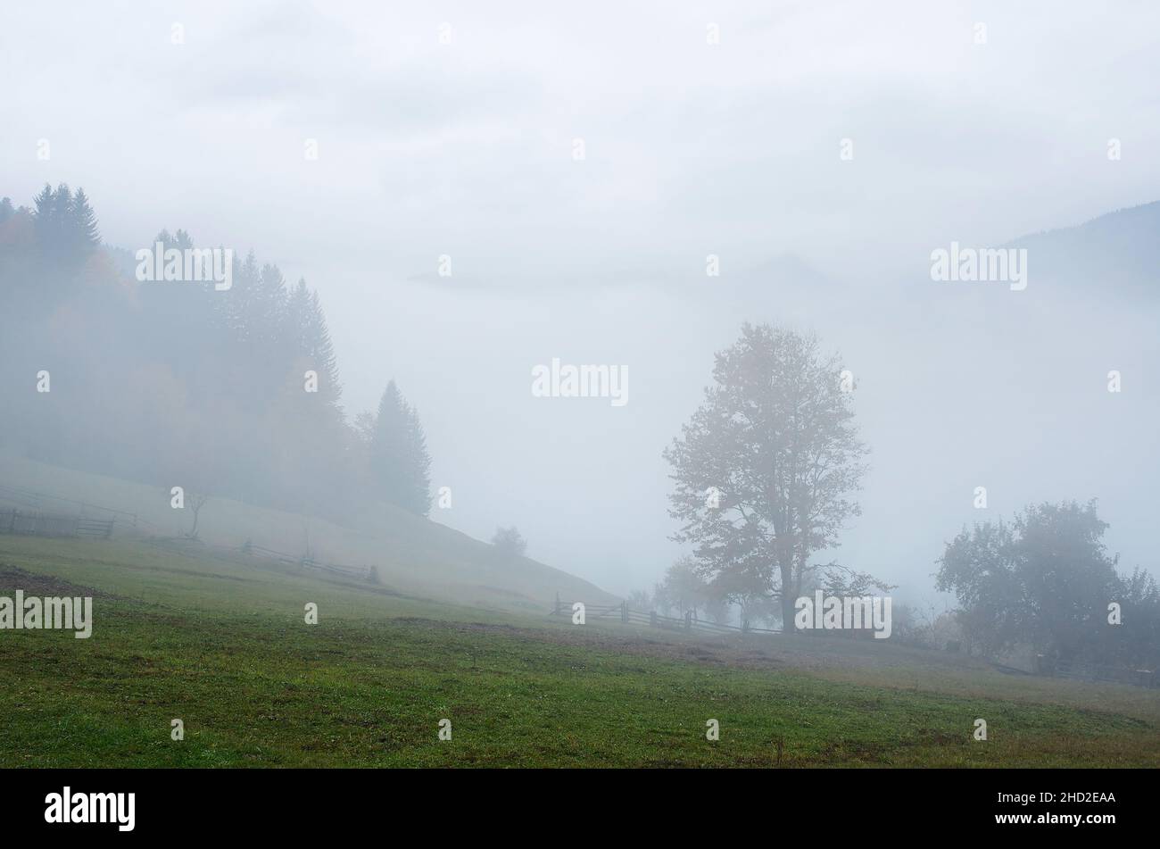 Fog in the mountainous village. Autumn landscape. Carpathians, Ukraine, Europe Stock Photo