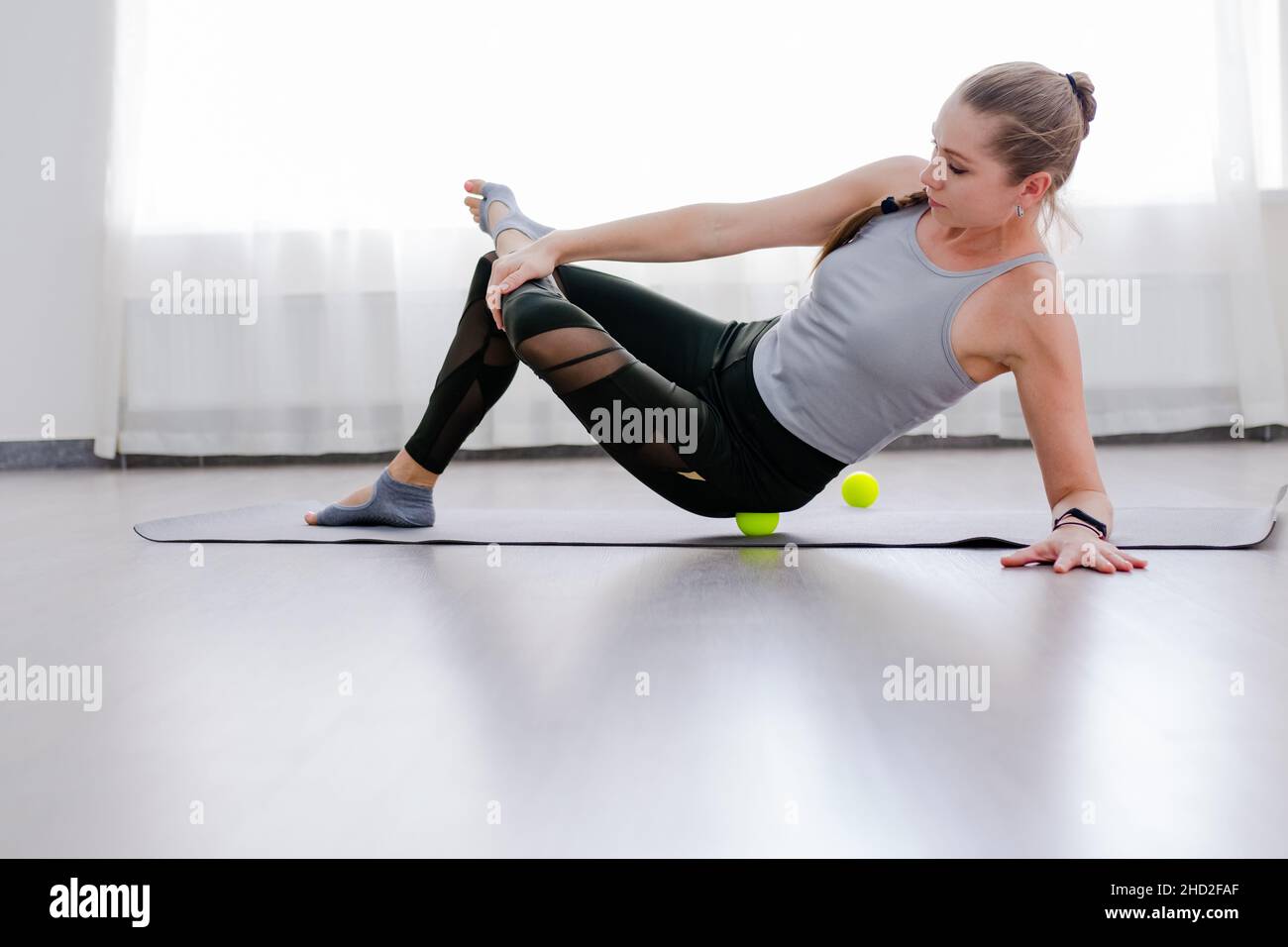 Woman use Myofascial release massage balls on hip selective focus Stock