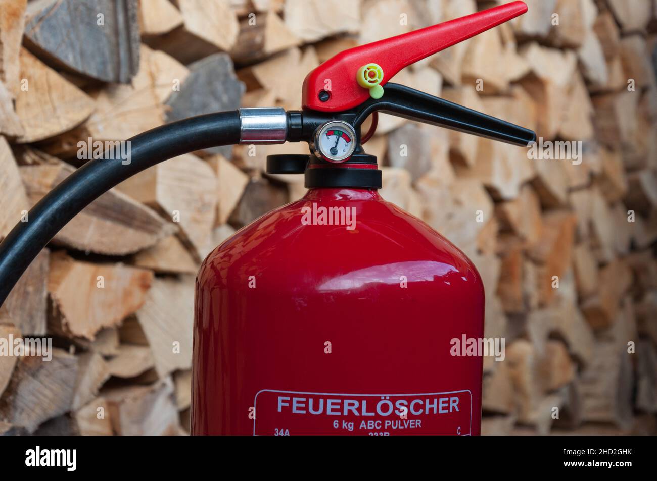 fire extinguisher detail of the pressure gauge, pile of wood in