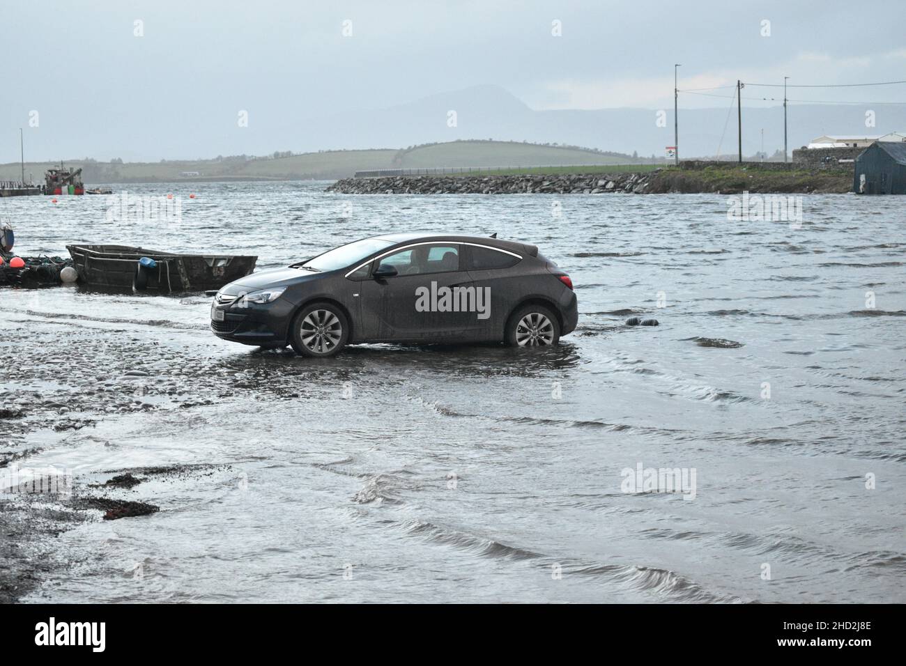 Bantry, West Cork, Ireland. 2nd Jan, 2022. As the High tide reaches the Bantry quay, the parking lot nearby floods. Cedit: Karlis Dzjamko/Alamy Live News. Stock Photo