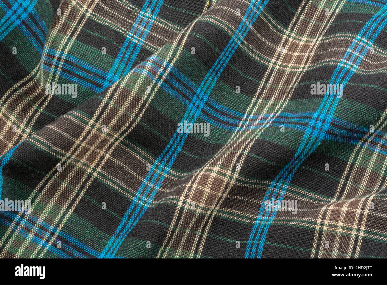 Close-up of blue check flannel fabric, showing warp and weft pattern thread pattern and blue stitching. Stitched line, lines of stitches. Stock Photo