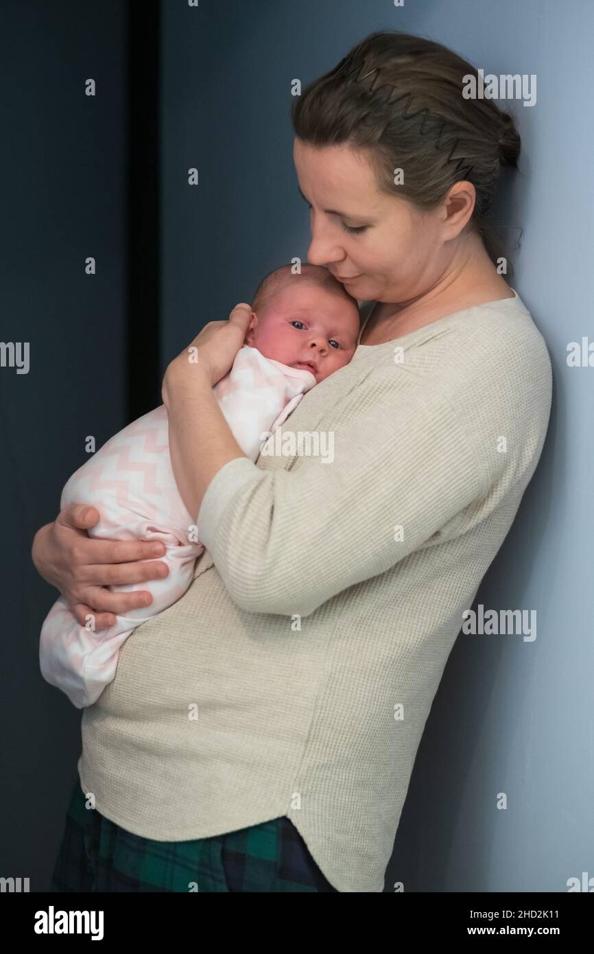 Caring young mother hold lean to chest newborn. Relax enjoy tender