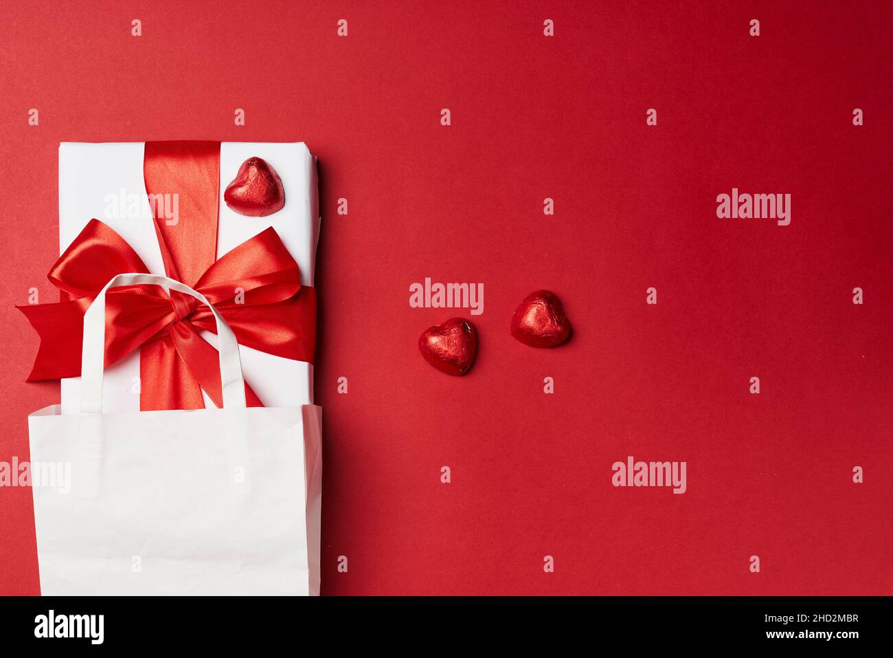Valentines day gift on red background. Heart shape gift box with ...