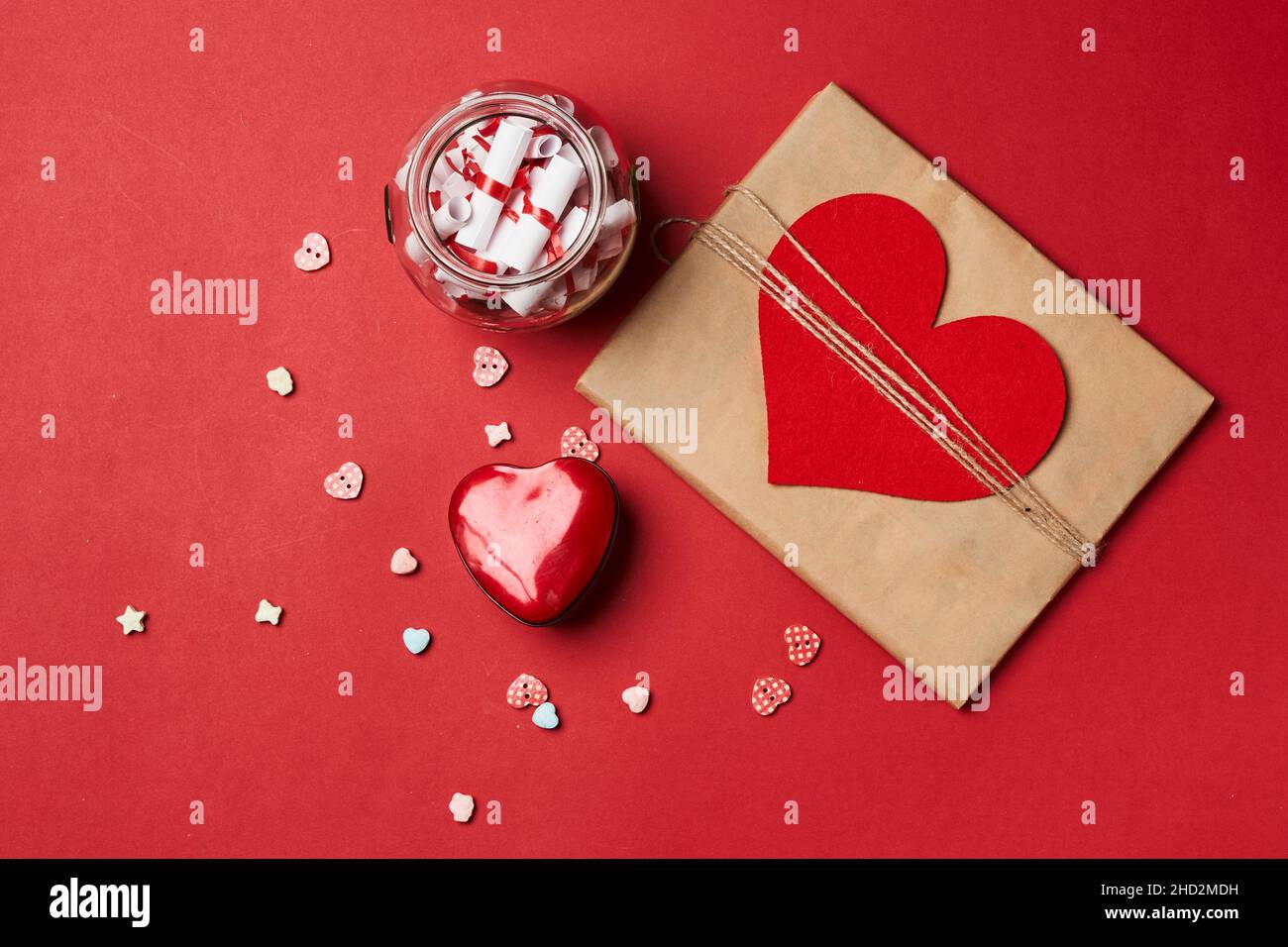 Valentines day gift on red background. Heart shape gift box with surprise. Love day concept. Anniversary, mothers day, womens day and birthday Stock Photo