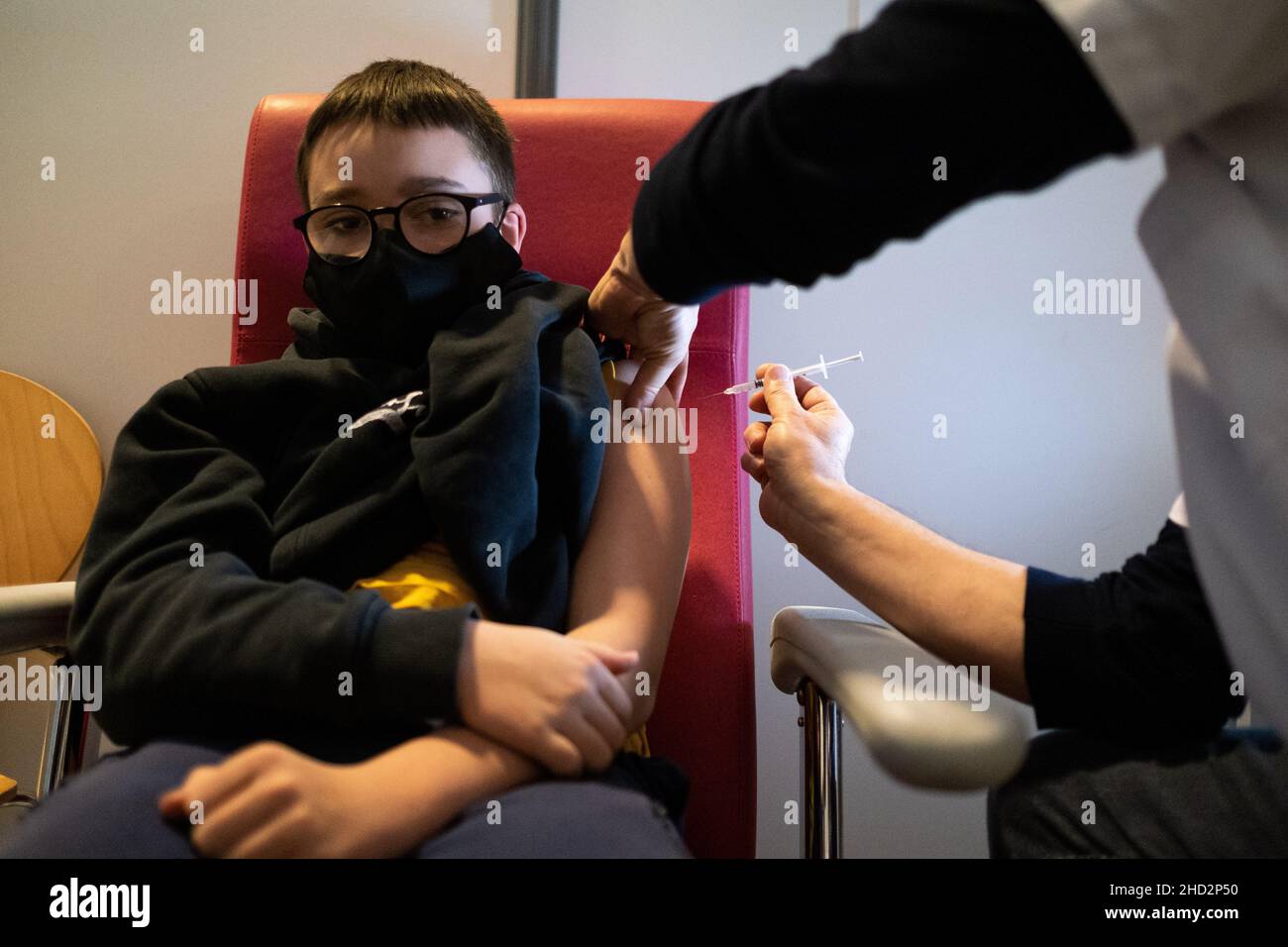 Vaccination of a twelve year old child with a Pfizer vaccine at a Covid ...
