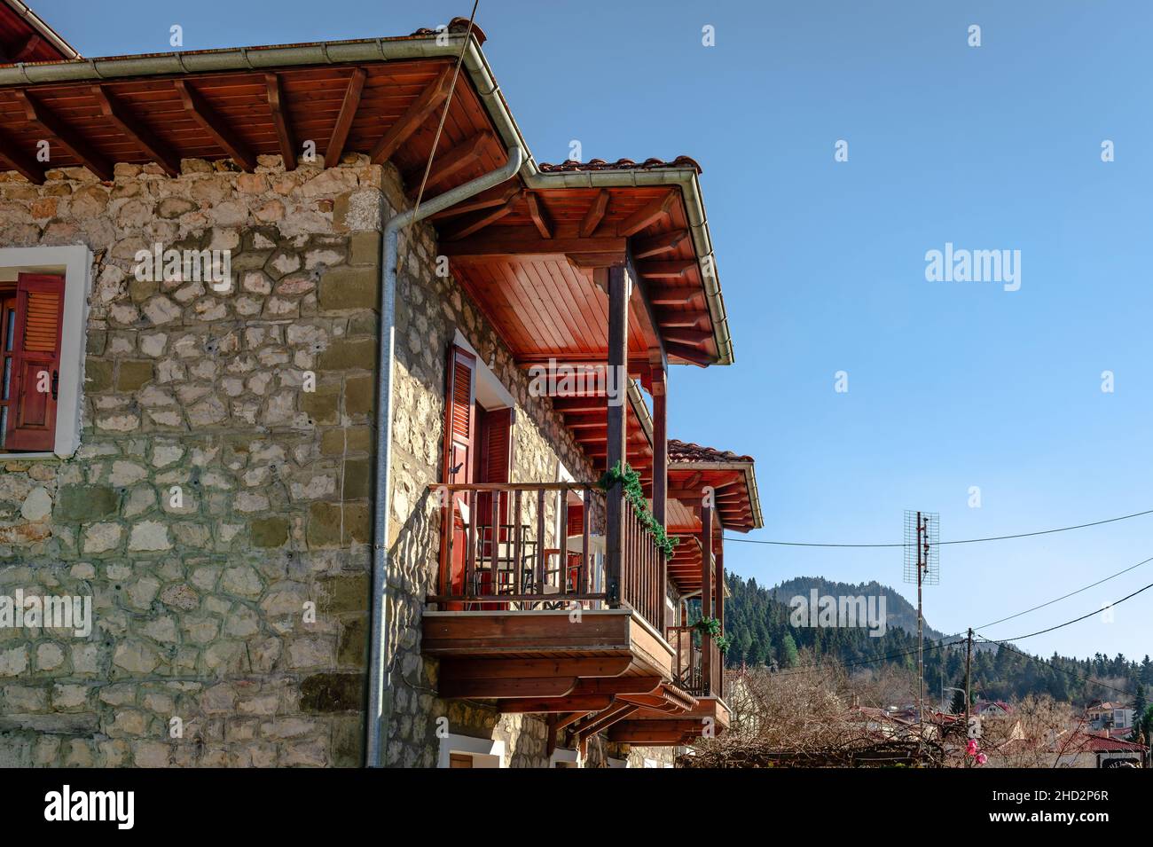 Traditional 2-storey stone house with wooden balcony in Elati, a mountainous village and popular resort  in the Trikala Prefecture, Greece. Stock Photo