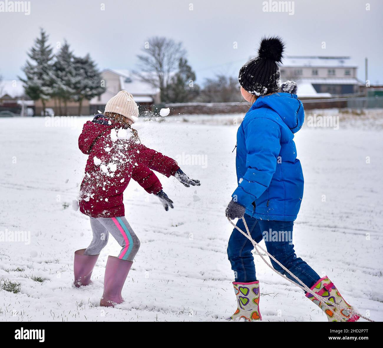 Pictured: Sisters Kerry Anne (7) and Jessica McBeth (9) from Armadale have some fun in the snow.  The first falls of snow in central Scotland meant fun in the snow for kids in Armadale, West Lothian.  (c) Dave Johnston Stock Photo