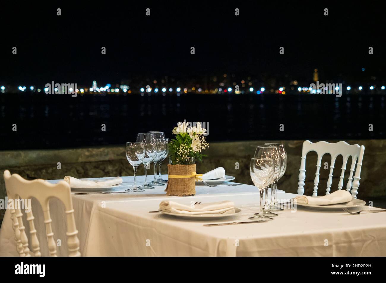 Empty restaurant table on a summer evening in front of the sea Stock Photo