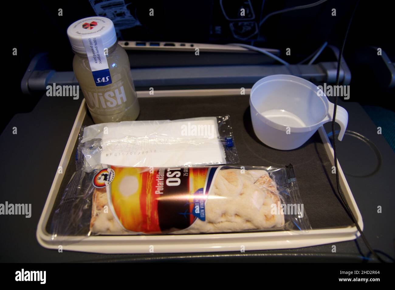 STOCKHOLM, SWEDEN - 24 NOV 2018: Inflight snack on an economy class flight. Plane meal consisting of smoothie and wrap Stock Photo