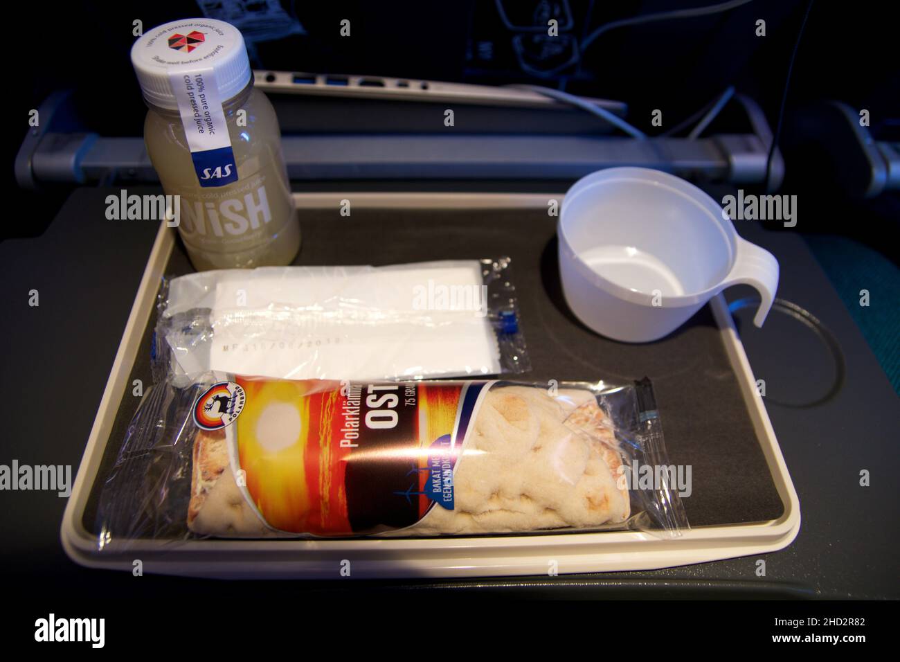 STOCKHOLM, SWEDEN - 24 NOV 2018: Inflight snack on an economy class flight. Plane meal consisting of smoothie and wrap Stock Photo