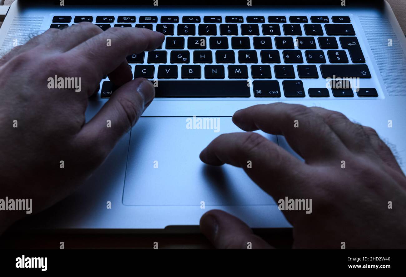 Apple Macbook Pro, typing and using touchpad with both hands Stock