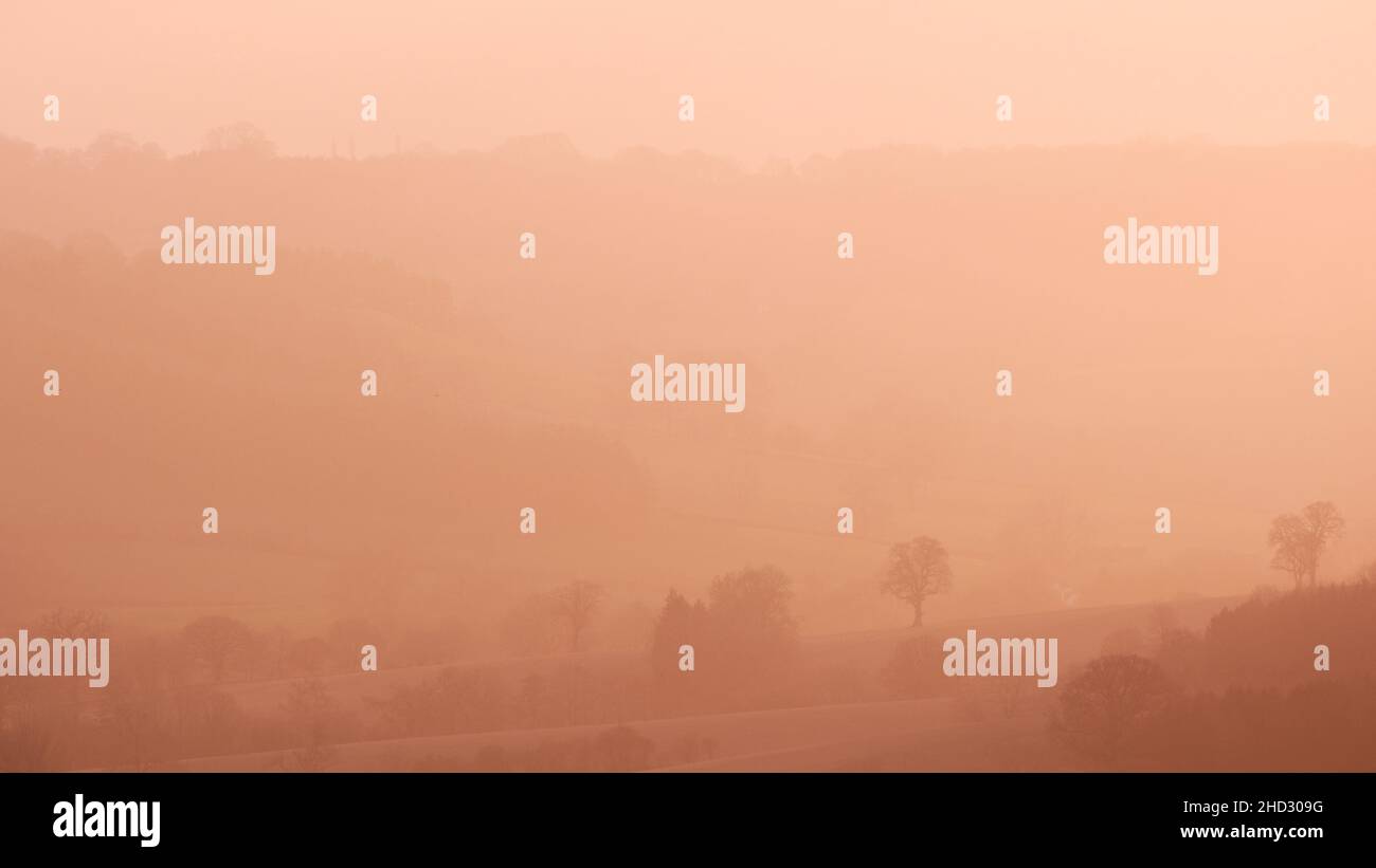 Scenic hills of Shropshire in late evening haze at sunset. Taken at the warmest New Years Day recorded in UK Stock Photo