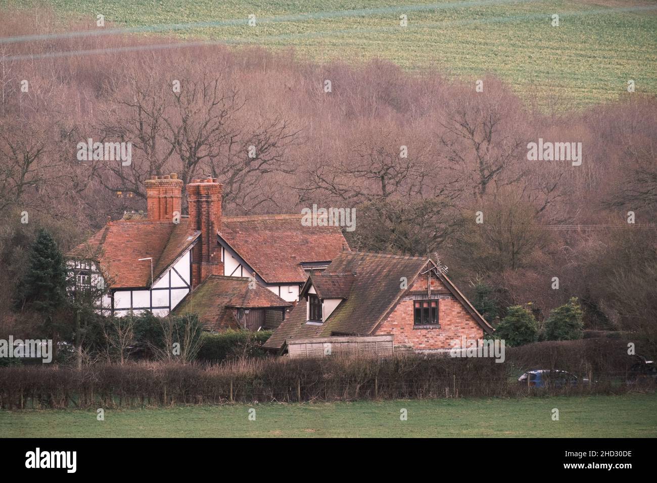 Traditional British farmhouse among trees and farmland. Shropshire in the United Kingdom Stock Photo