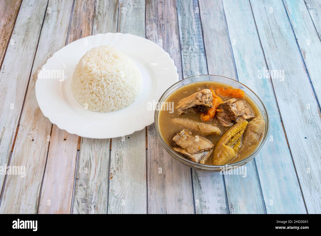 Sancocho is a stew made with tubers, vegetables, condiments, meats and a plate of white rice. Stock Photo