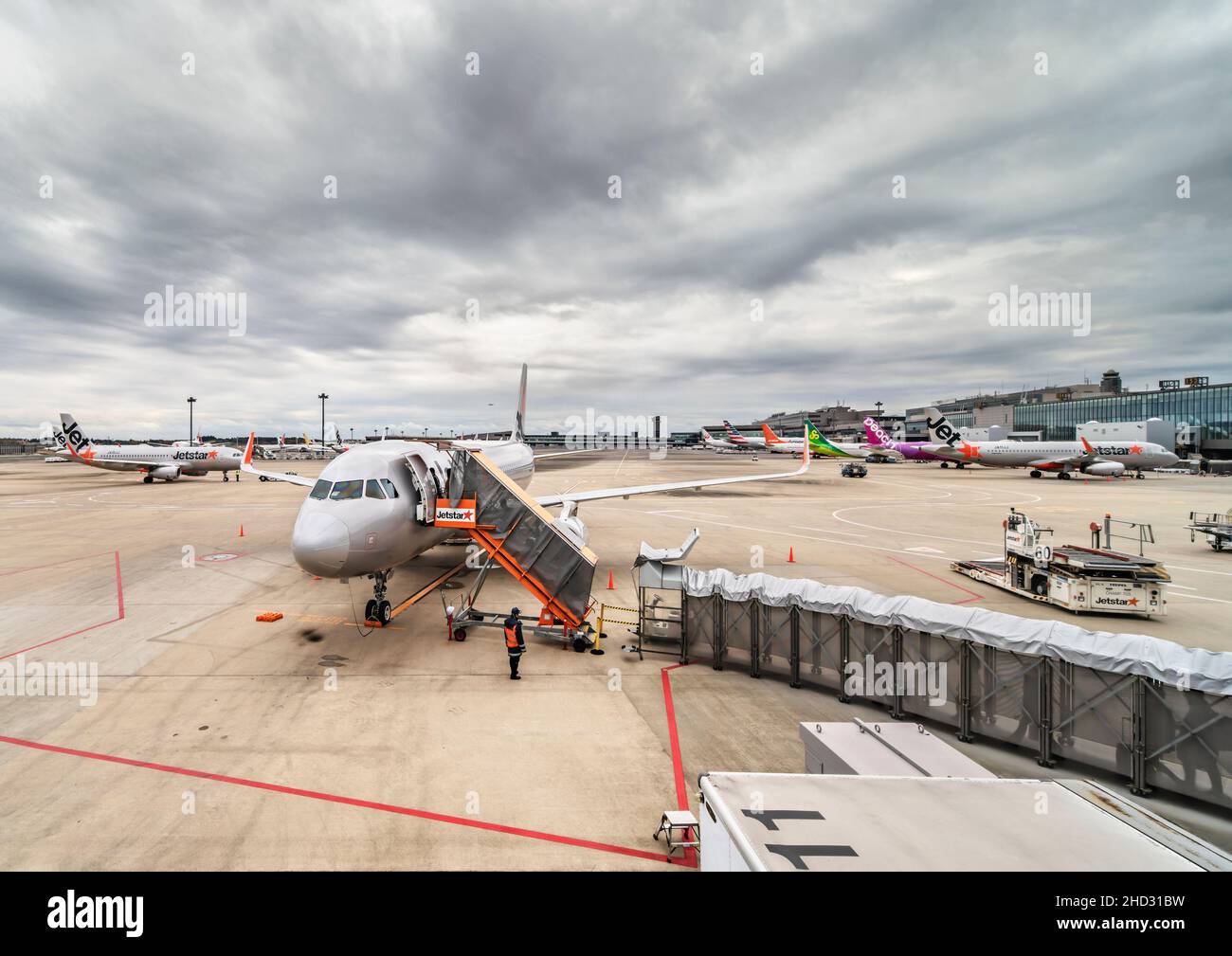 tokyo, japan - december 06 2021: Airbus plane from Japanese low-cost carrier airline jetstar airways boarding passengers on the apron or tarmac of the Stock Photo