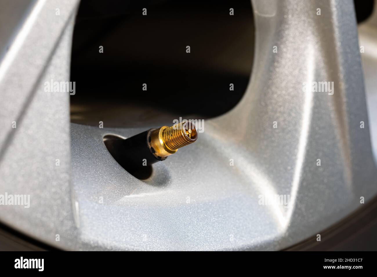 Tire valve stem on car wheel. Vehicle safety, tire wear, fuel mileage and winter checkup concept. Stock Photo