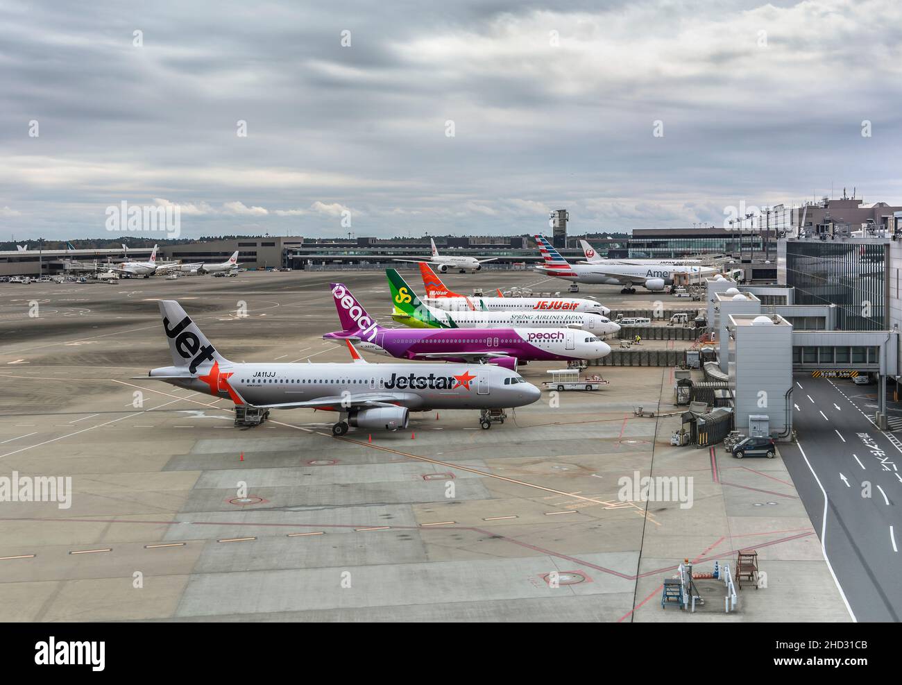 tokyo, japan - december 06 2021: Boeing and airbus planes from Japanese low-cost carriers or low-cost airlines parked on the apron or tarmac of the Na Stock Photo