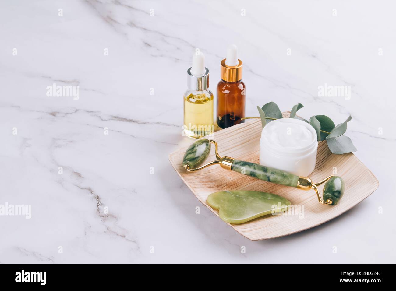 Jade facial roller and gua sha tool with beauty serum, face oil and