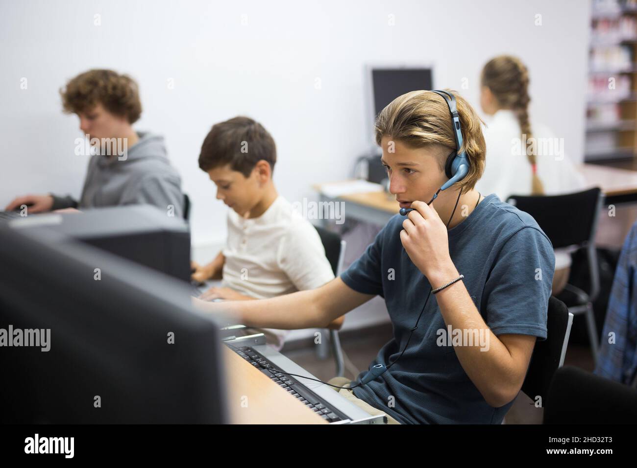 Teenager boy in computer class Stock Photo - Alamy